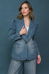 A washed denim blazer featuring front button closure, front pockets and long sleeve