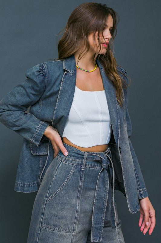 A washed denim blazer featuring front button closure, front pockets and long sleeve