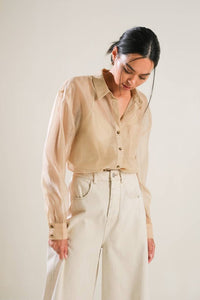 A solid organza top with contrasting collar and placket, long sleeve, button down and cami