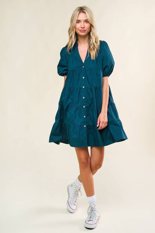 A solid woven mini dress featuring V neckline, short puff sleeve