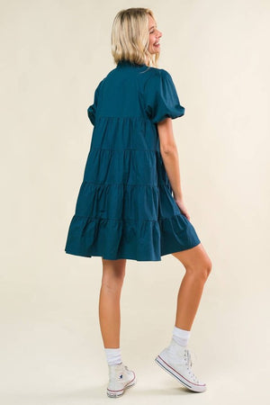 A solid woven mini dress featuring V neckline, short puff sleeve