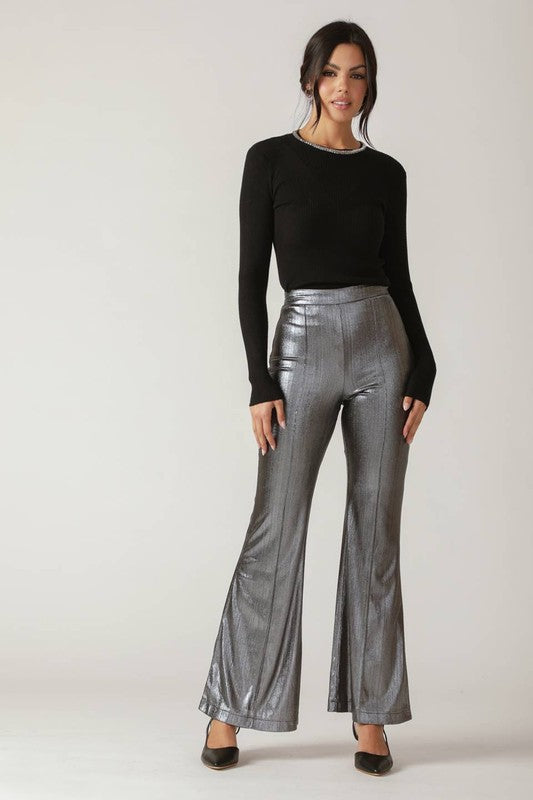 A foil coated woven pant featuring side zipper and flare leg