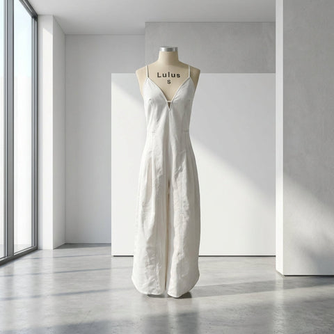 Full-body view of Solid Woven Jumpsuit on mannequin in modern minimalist setting, natural light emphasizing fabric structure.