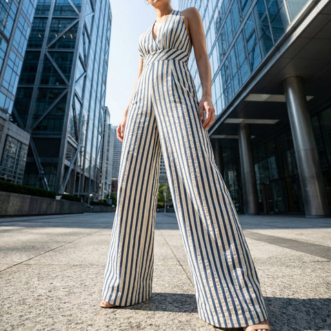 Full-length view of Stripe Jumpsuit on model in urban setting, highlighting fit, length, and stylish silhouette with natural daylight.