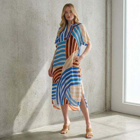 Editorial full-body shot of model in Stripe Abstract Print Midi Dress demonstrating flowing fabric, side slit, and elegant silhouette in studio.