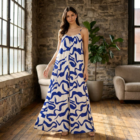 Medium shot of the jumpsuit in a stylish urban loft interior on a hanger, with natural window light emphasizing fabric drape and texture.