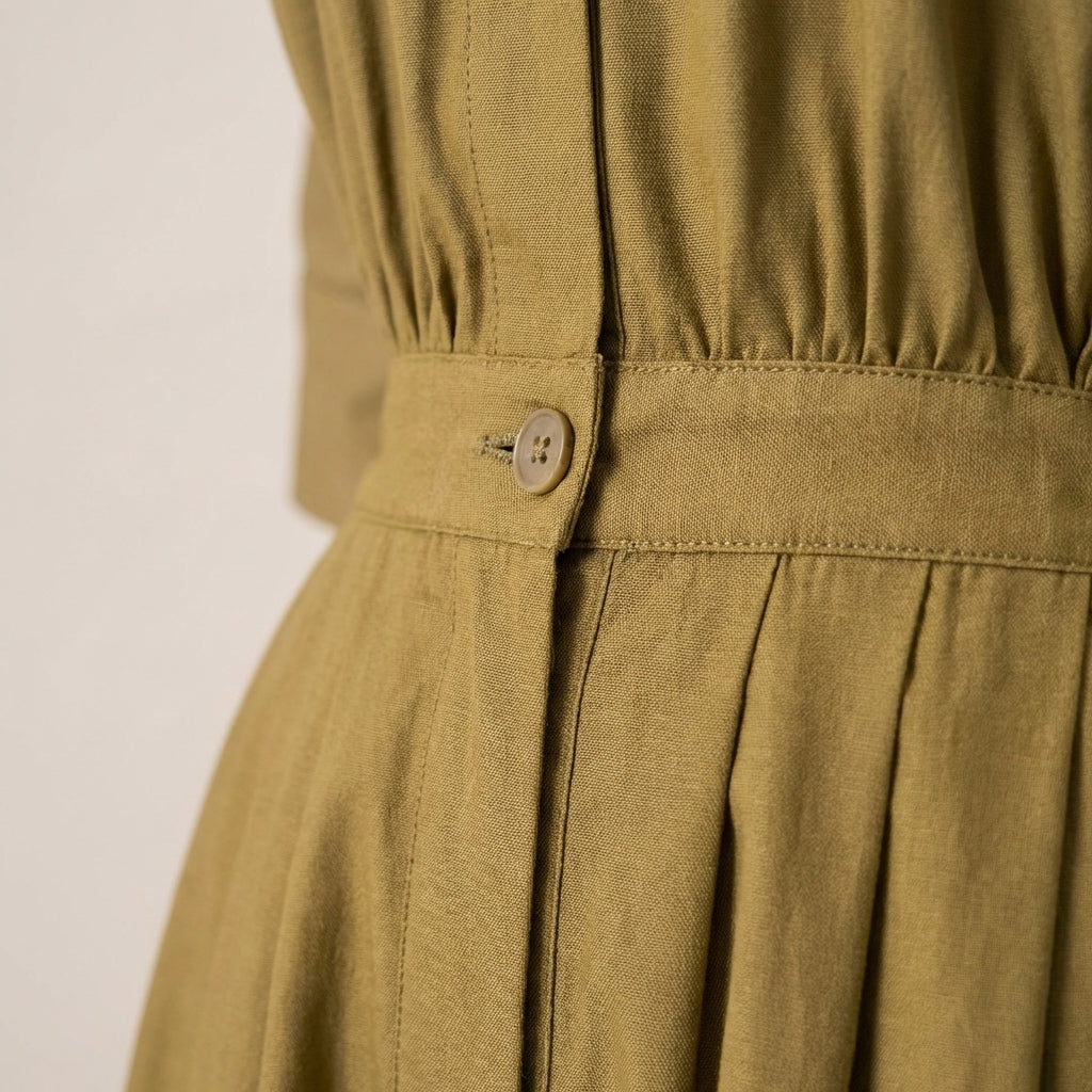  Macro shot highlighting the detailed woven fabric texture and subtle sheen of the jumpsuit.