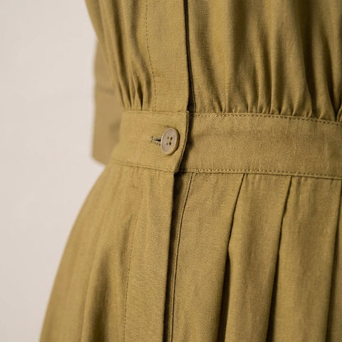  Macro shot highlighting the detailed woven fabric texture and subtle sheen of the jumpsuit.
